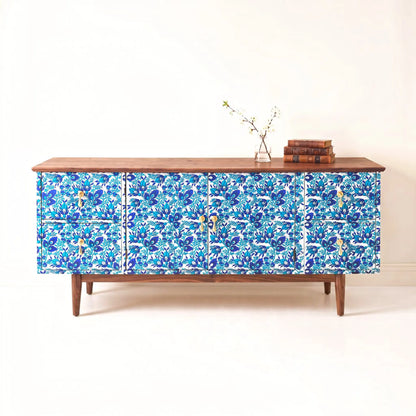 A mid-century modern sideboard cabinet  decoupaged with a blue and white floral pattern