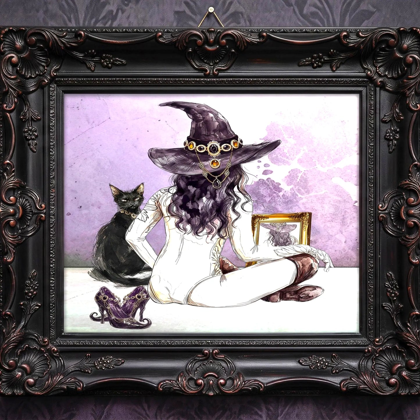 A framed art print featuring a gothic illustration of a witch with a purple hat and goggles, seated cross-legged with a black cat beside her, all enclosed in an ornate dark brown carved frame.