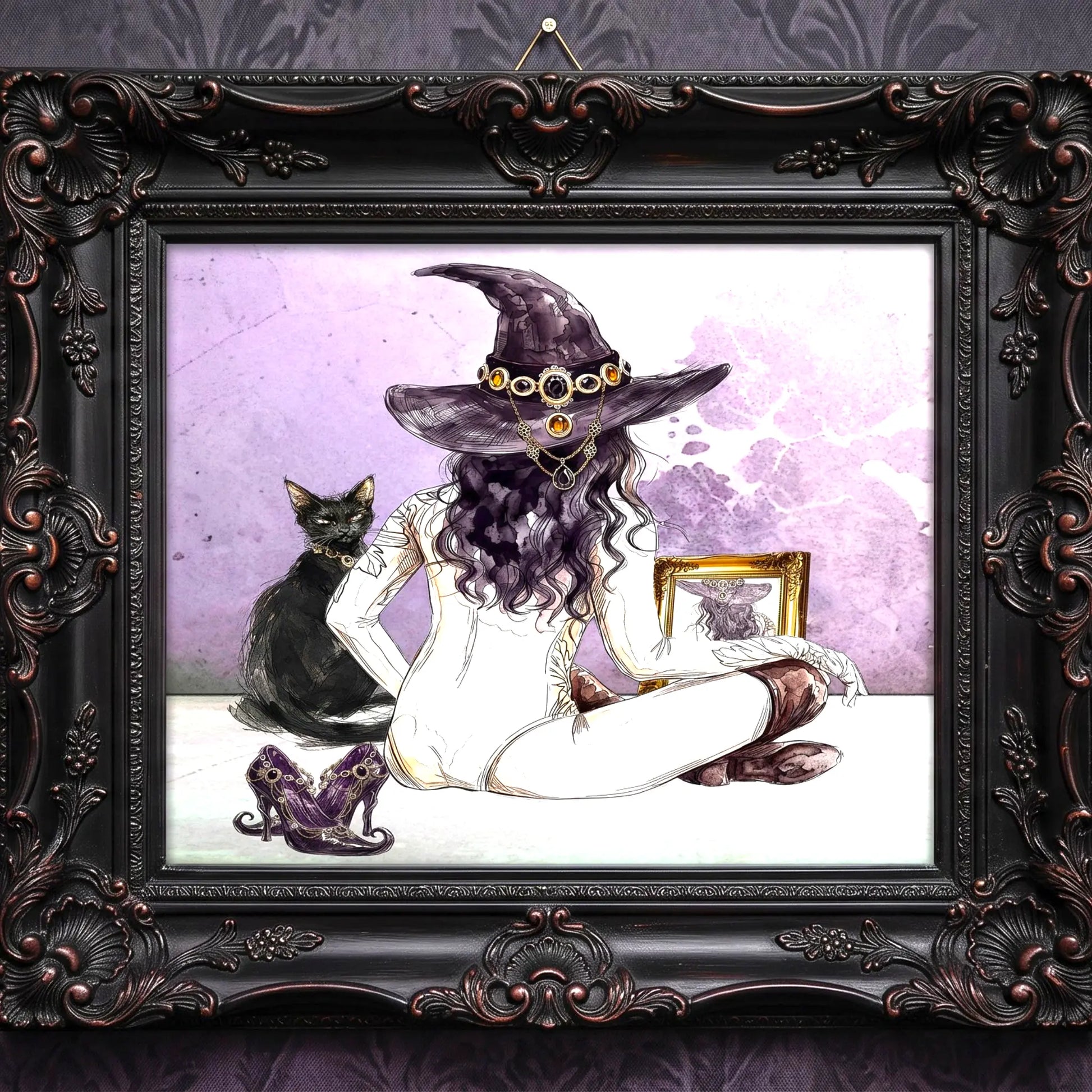 A framed art print featuring a gothic illustration of a witch with a purple hat and goggles, seated cross-legged with a black cat beside her, all enclosed in an ornate dark brown carved frame.