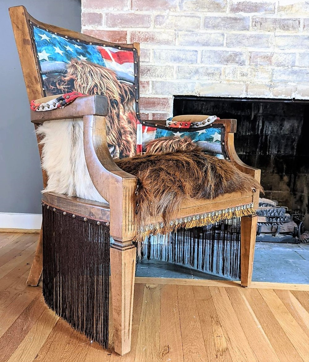 Elevate your farmhouse decor with this stunning Western Style Brown Leather Chair, a perfect blend of rustic charm and vintage appeal. Crafted from reclaimed wood and upcycled materials, this unique piece features a distressed brown leather frame that exudes cowboy cool. The upholstery is adorned with a striking Highland cow print, adding a touch of countryside authenticity, while the goat-skin hides drape gracefully over the seat, offering both comfort and texture.