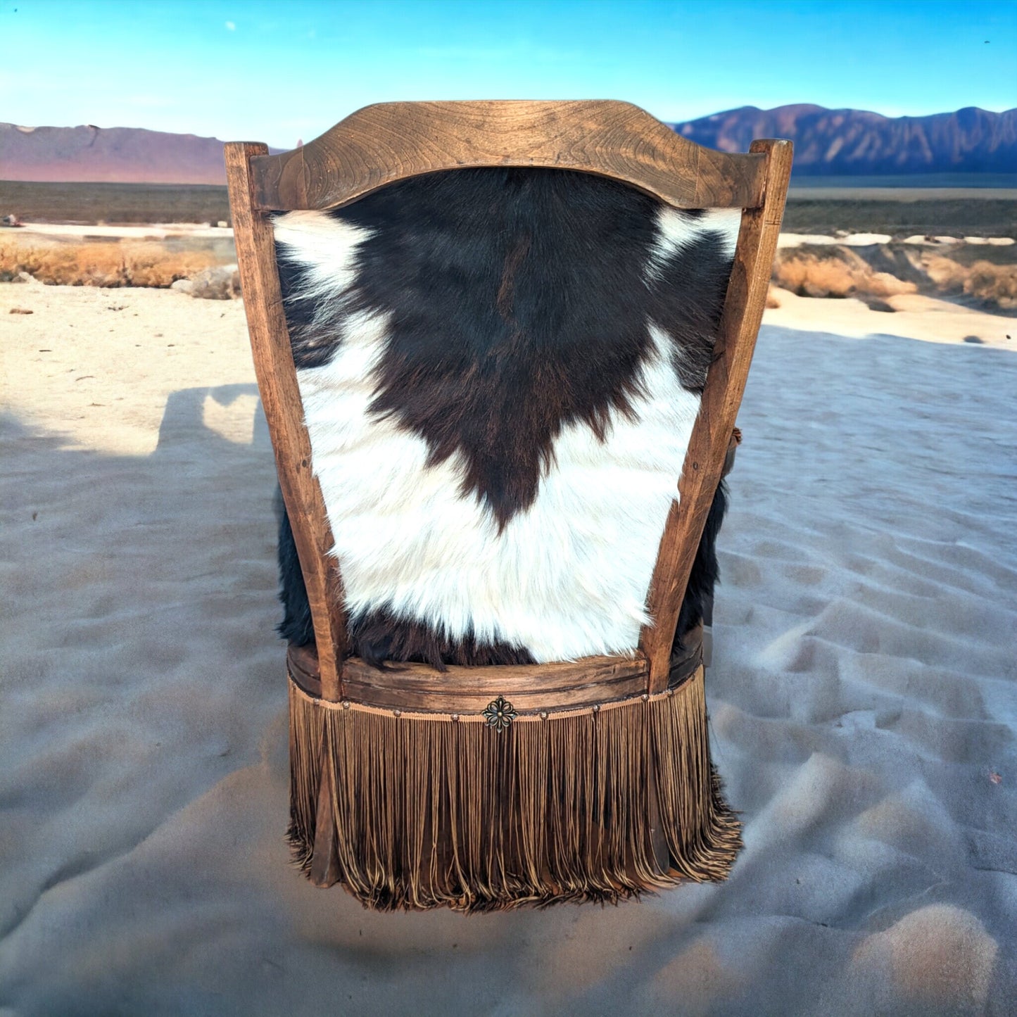 Elevate your farmhouse decor with this stunning Western Style Brown Leather Chair, a perfect blend of rustic charm and vintage appeal. Crafted from reclaimed wood and upcycled materials, this unique piece features a distressed brown leather frame that exudes cowboy cool. The upholstery is adorned with a striking Highland cow print, adding a touch of countryside authenticity, while the goat-skin hides drape gracefully over the seat, offering both comfort and texture.