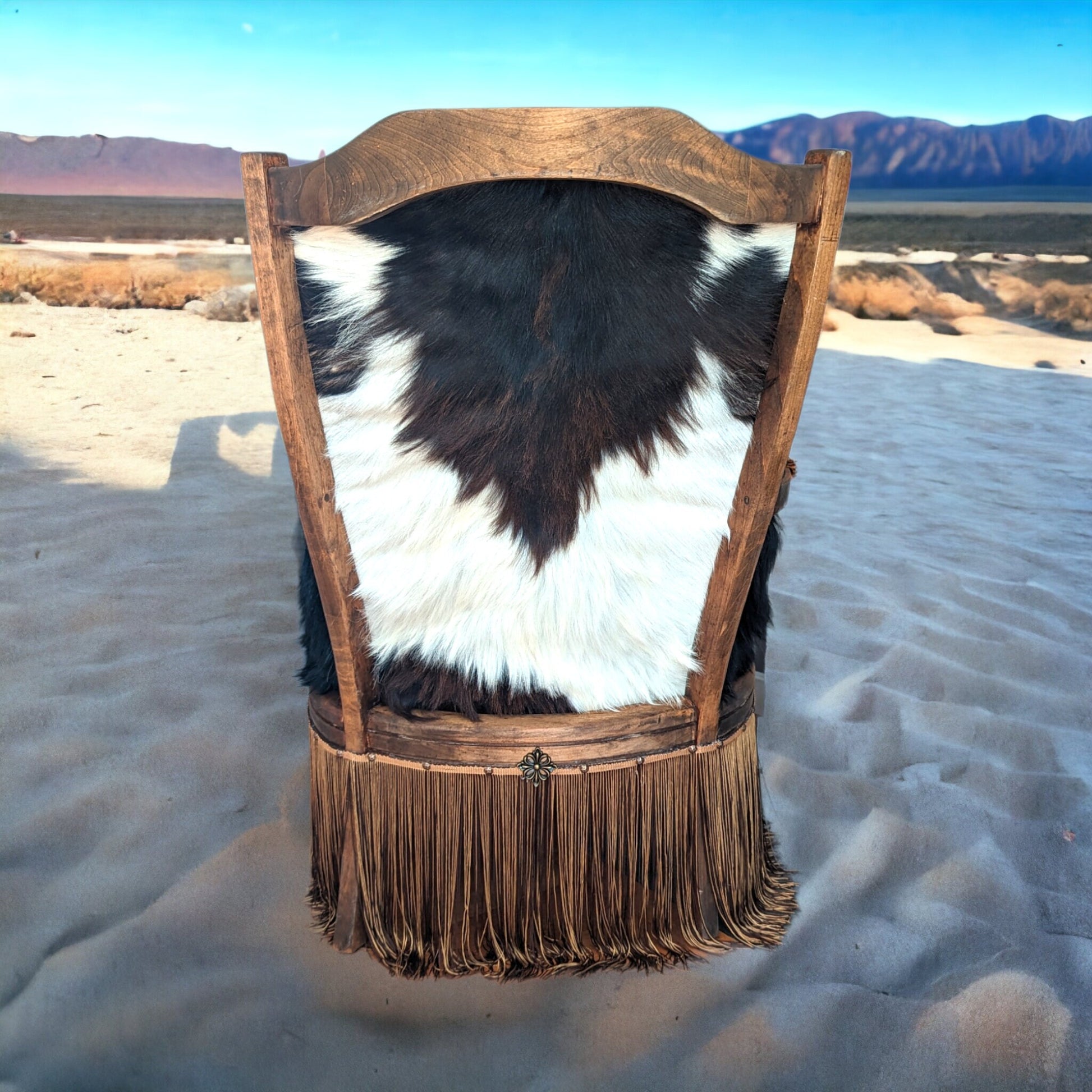 Elevate your farmhouse decor with this stunning Western Style Brown Leather Chair, a perfect blend of rustic charm and vintage appeal. Crafted from reclaimed wood and upcycled materials, this unique piece features a distressed brown leather frame that exudes cowboy cool. The upholstery is adorned with a striking Highland cow print, adding a touch of countryside authenticity, while the goat-skin hides drape gracefully over the seat, offering both comfort and texture.