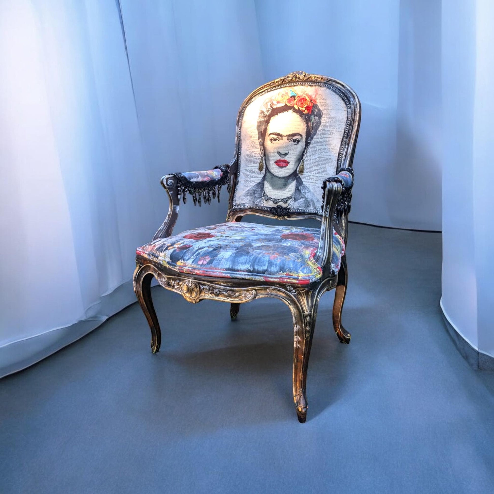 Bring style and character to your home decor with this one-of-a-kind Frida Kahlo vintage French upcycled chair. The chair frame is made of solid wood, painted black, and decorated with gold wax. Chair decsorated with extar large black tassels.