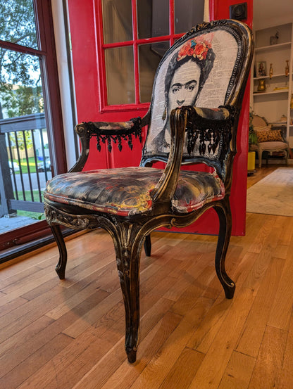Bring style and character to your home decor with this one-of-a-kind Frida Kahlo vintage French upcycled chair. The chair frame is made of solid wood, painted black, and decorated with gold wax. Chair decsorated with extar large black tassels.