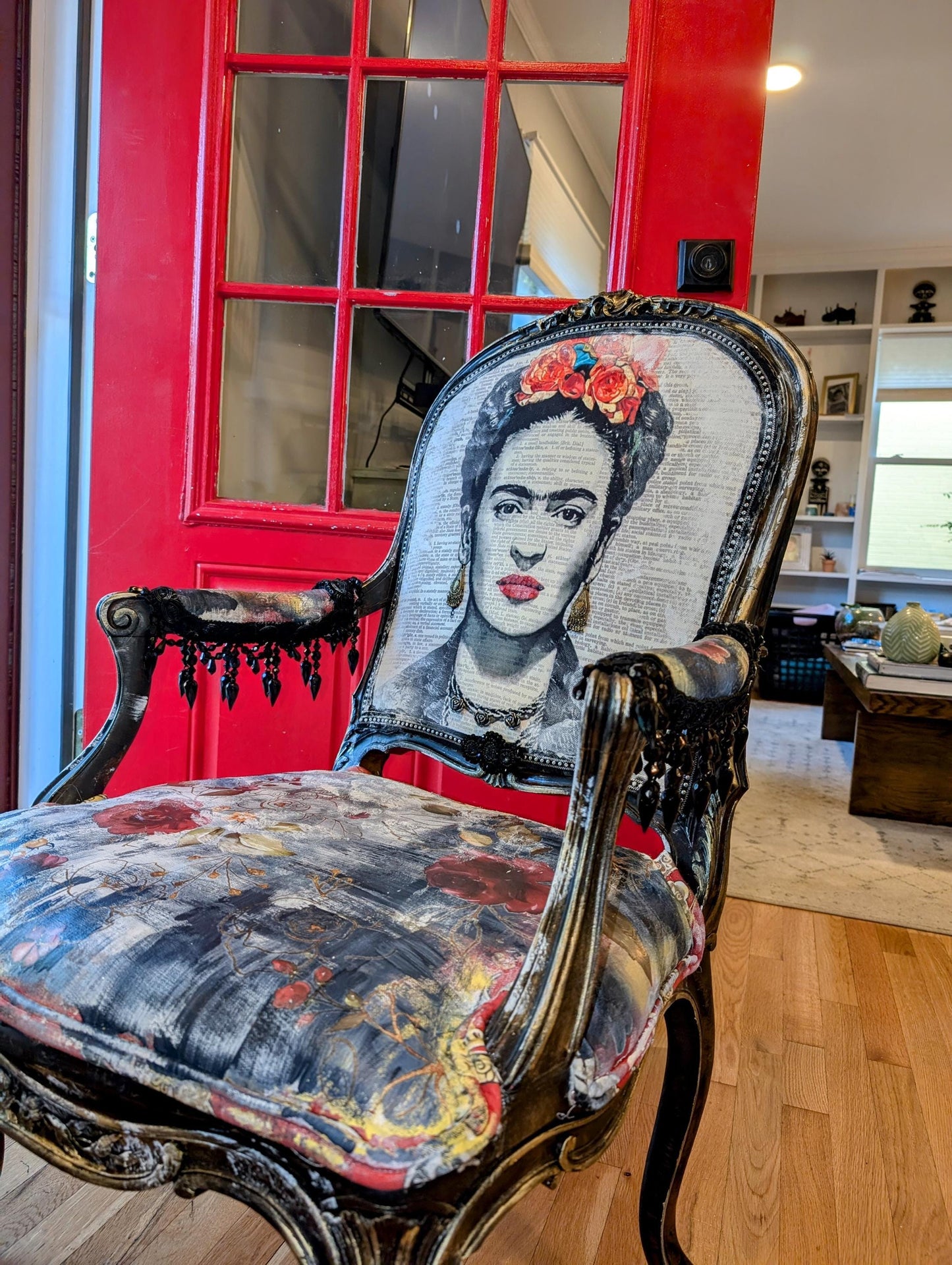 Bring style and character to your home decor with this one-of-a-kind Frida Kahlo vintage French upcycled chair. The chair frame is made of solid wood, painted black, and decorated with gold wax. Chair decsorated with extar large black tassels.