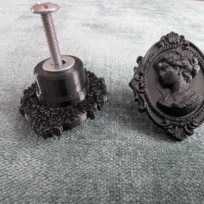 Add a touch of gothic elegance to your furniture with this stunning 3D-printed Cameo Cabinet Drawer Pull. Designed to elevate your cabinetry, this drawer knob combines vintage charm with modern craftsmanship, making it perfect for furniture hardware, wardrobe handles, kitchen hardware, and bathroom remodels. Crafted with attention to detail, this gothic-inspired drawer pull features intricate carved accents that evoke a sense of timeless sophistication.