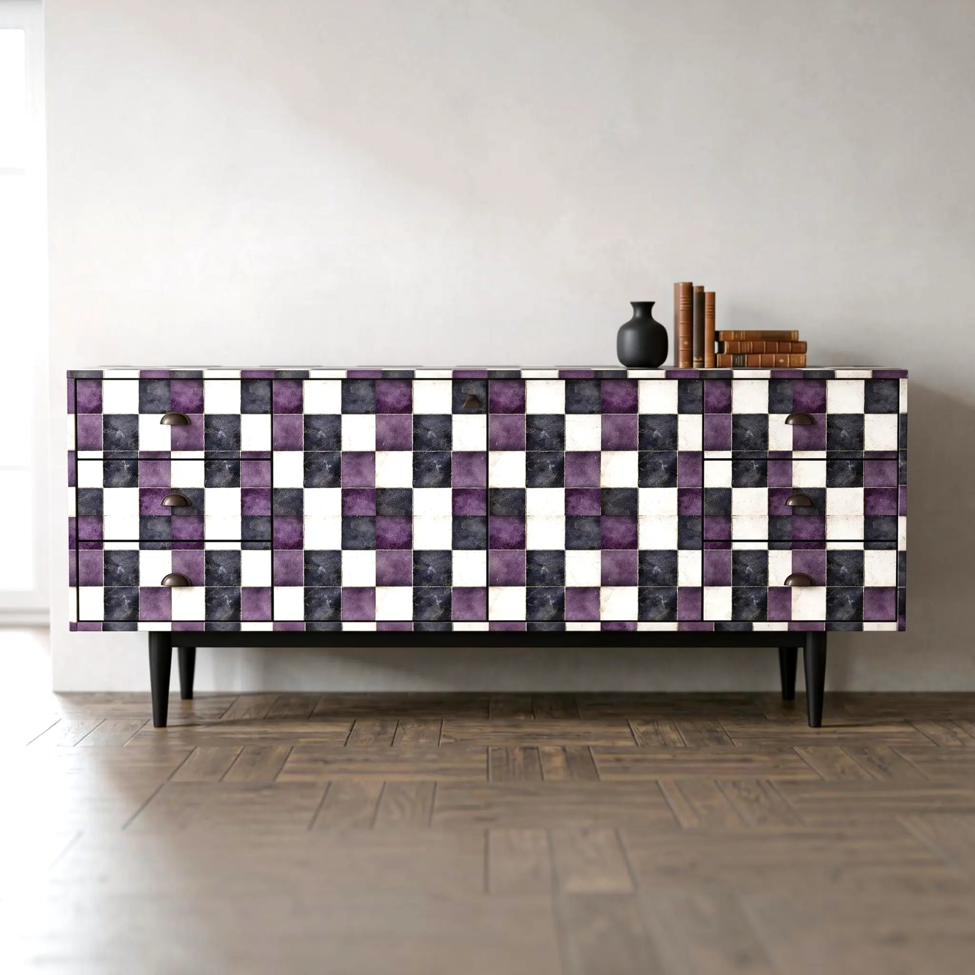 A mid-century modern sideboard with a checkerboard pattern of purple, black, and white textured tiles, set against a minimalist light gray wall and dark wood parquet floor.