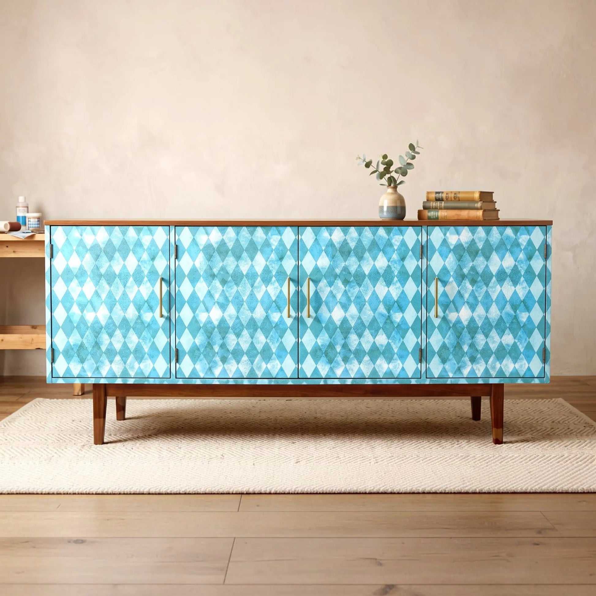 A mid-century modern credenza upcycled  white teal green harlequin diamond pattern, featuring a medium brown wood top and legs, set in a styled room on a beige rug.
